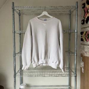Basic white Russell sweatshirt. There’s some stains that can be removed with some bleach.   MADE IN USA