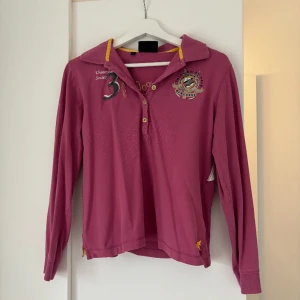 HV polotröja  - Rosa tröja från HV polo. Köpt second hand, aldrig använd av mig. Storlek L men passar S/M.