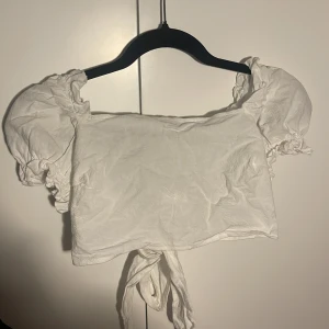 Vit sommartopp - Täcker typ brösten? Aldrig använd. Linnelikt marerial. Knyt där bak. Märke shein