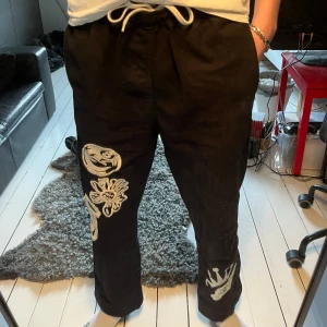 STÜSSY svarta byxor med broderi - De vita detaljerna är broderade och byxorna är i bra kvalite. 9/10 inga skador  längd (från toppen till botten) = ca 1 meter bredd (midjan) = ca 88 cm 