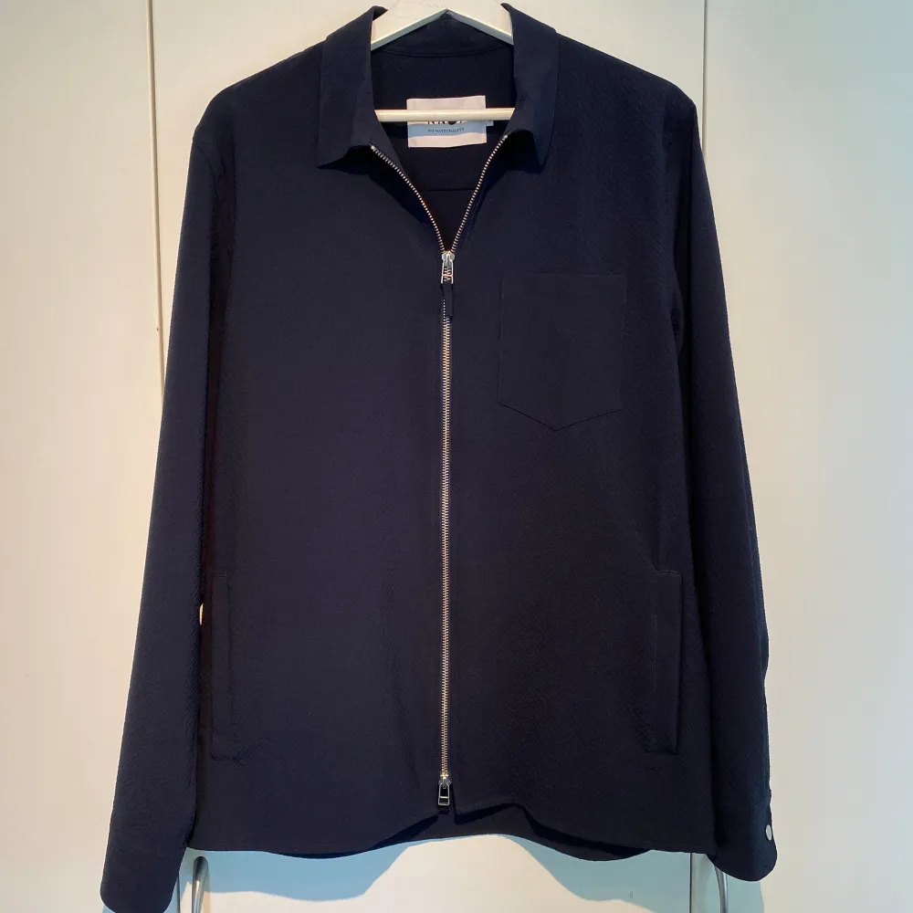 Hej, säljer en sjukt fräsch overshirt med zip från No Nationality i marinblå färg. Endast använd en gång så utmärkt skick. Storlek M och True to Size. Nypris 2500kr. Kvalitativ och stilren. Pris kan diskuteras. Hörs i DM!. Tröjor & Koftor.