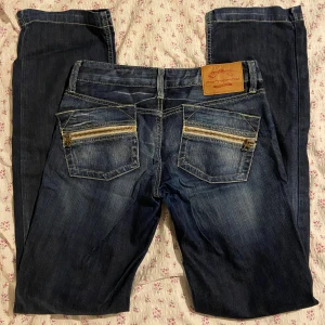 Low Waisted Jeans  - Vintage straight leg, super low waist jeans. Super cute design with detailed back pockets.