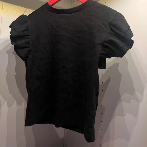 Volang tröja/ t-shirt. - Köpt på Gina trico och är i bra skick.Tröjan ör inte jätte lång men går under naveln. På mig sitter tröjan bra varken för plastig eller tajt.