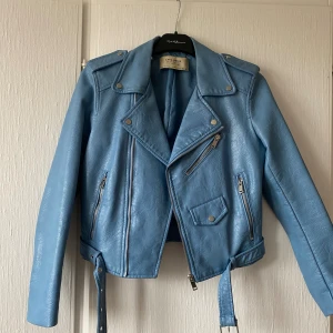 Blå skinnjacka - Blå skinnjacka från Zara i storlek S, dock mindre i storlek. Har defekt precis i kragkanten (syns på bild 3).