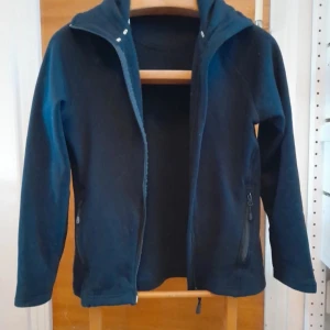 Tröja - En mjuk tröja med dubbel dragkedja, har två fickor med dragkedjor. 