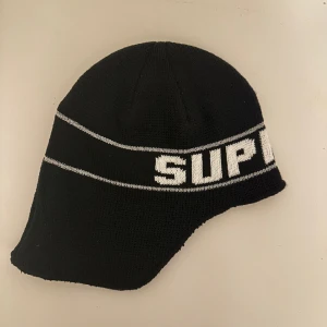 SUPREME FLAP EAR BEANIE - Brand new with original packaging.  One size.