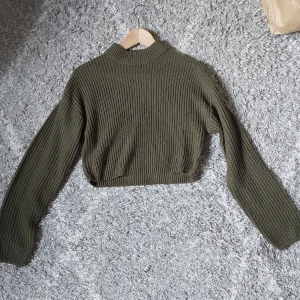 Olivgrön stickad tröja från H&M - En olivgrön stickad tröja som är lite croppad. Super fin och mysig i mycket bra skick. Storlek xs men passar även xxs - s.