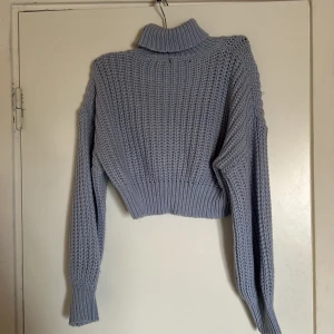 Ljusblå stickad polotröja från SHEIN - Säljer en superfin ljusblå stickad polotröja från SHEIN. Den är i storlek 38 och har en mysig, ribbad polokrage. Tröjan är croppad och har långa ärmar med ribbade muddar. Perfekt för höst och vinter! 💙