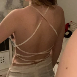 Klänning med öppen rygg  - Klänning i ljusrosa färg. Öppen i ryggen med snörning. Storlek S. Mycket fin och bra skick. Använd 1/2 gånger. Okänt märke då lapp saknas. 