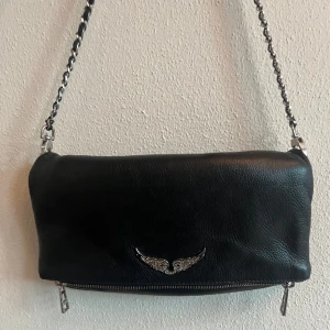 Zadig väska - Säljer min fina zadig väska "Rock Clutch" som jag köpte för 1,5 år sedan i Stockholms egna zadig butik för 3600kr. Inga defekter, bytt axelrem för ett år sen då det första gick sönder. Kvitto, dust bag och ett längre axelband medföljer. 