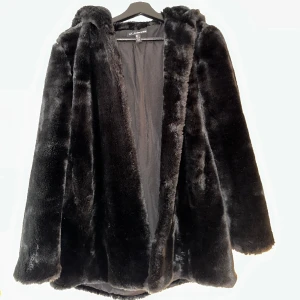 Pälsjacka med stor luva - Pälsjacka med stor luva, hyska och hake knäppning på jackan Ingen äkta päls