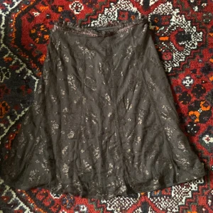 brun kjol - brun midikjol med blommig spets, knälängd och lågmidjad.