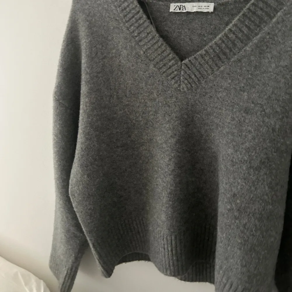 En grå stickad tröja från Zara med en fin v-ringning. . Stickat.