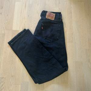 Ett par svarta Levis 501 jeans i väldigt bra skick. Jeansen passar både män och kvinnor, i storlek W33 L30