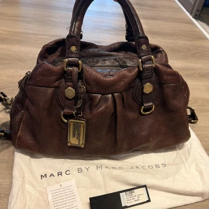 Marc Jacobs väska - Fler av Marc Jacobs väskor i profilen ->>>> Ett gammalt modell Marc Jacobs väska som är köpt för fler år sedan från NK. Botten har lite vatten skada (se 4e bilden)💐Tar emot bud