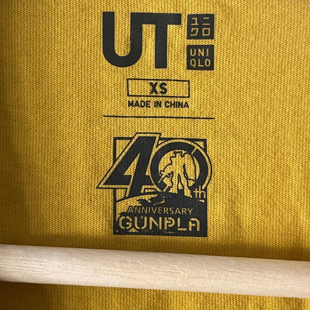 Gundam x Uniqlo Mecha 40yr Anniversary tee with prints on front and both arms. T-shirts.