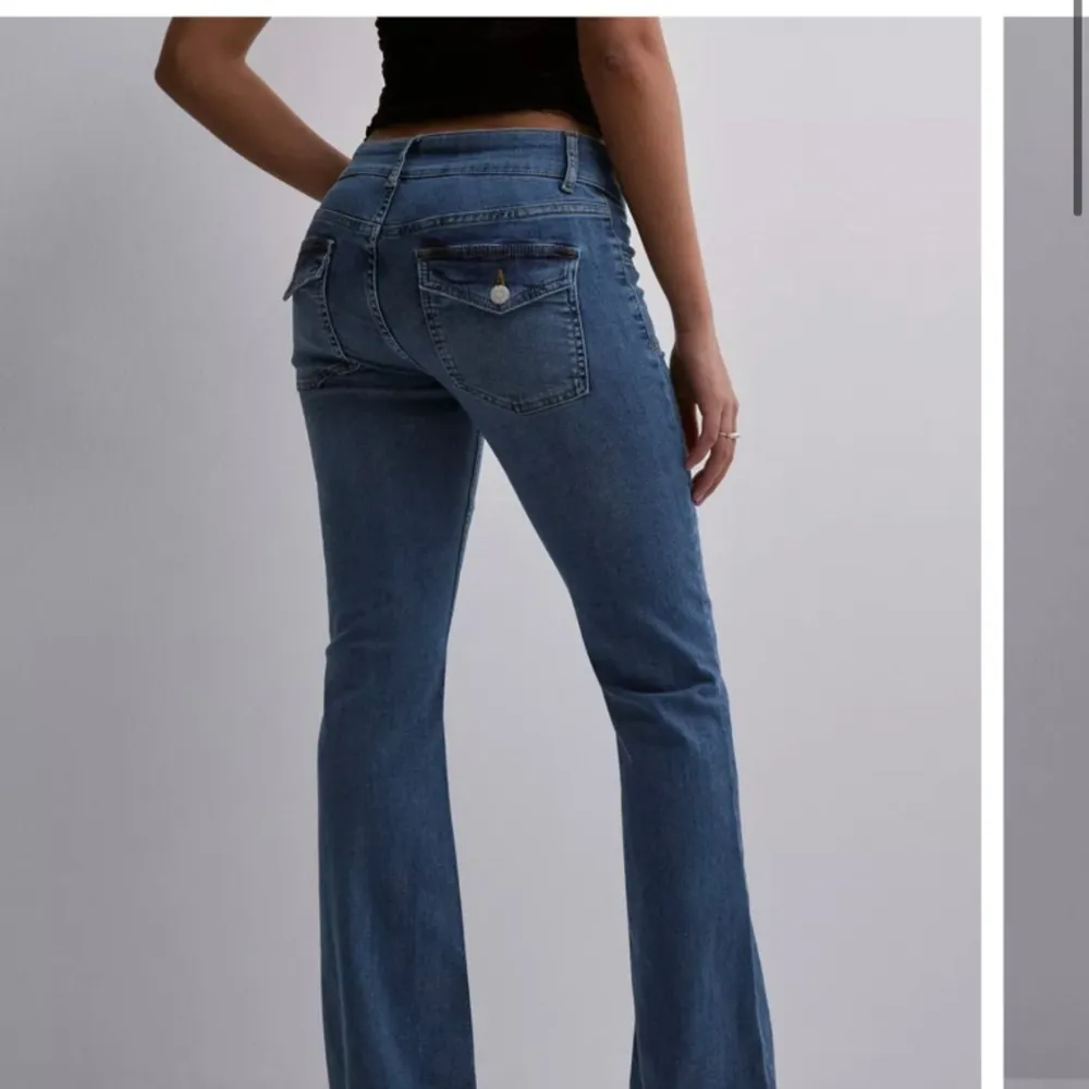 Säljer mina helt sprillans nya  lågmidjade bootcut jeans ifrån Nelly. Jeansen har en jätte fin mörkblå färg, med söta fickor med knappar på. Byxorna är sprillans nya och aldrig använda, dock är prislappen borta. Säljer då dessa inte kommer användas.. Jeans & Byxor.