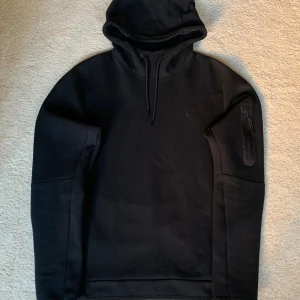 Nike Tech Fleece - Använd 3 gånger i princip ny och i väldigt bra skick. Inga defekter eller fläckar. Köpt helt ny från Nike-appen. Det är en Nike Tech Fleece Hoodie I stormed M. Nypris 1149 kr