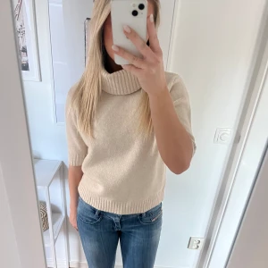 Stickad T-shirt  - Beige stickad T-shirt med polokrage! Aldrig använd med lappen kvar