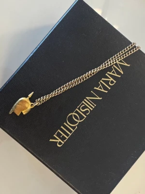 Guldigt halsband med elefantberlock - Ena halvan från Maria Nilsdotter, bra skick. Kontakta via intresse eller köp😊