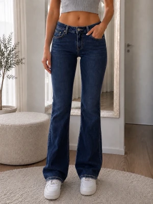Mira jeans mörkblå med låg midja - Säljer ett par mörkblå bootcut jeans med låg midja och i modell Mira .Jeansen har en snygg utsvängd passform och är tillverkade i denim med lätt stretch för skön komfort. Perfekta till sneakers eller boots!