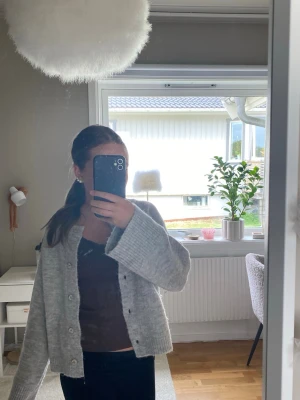 Ljus grå kofta med knappar - Stickad ljusgrå kofta med knappar 