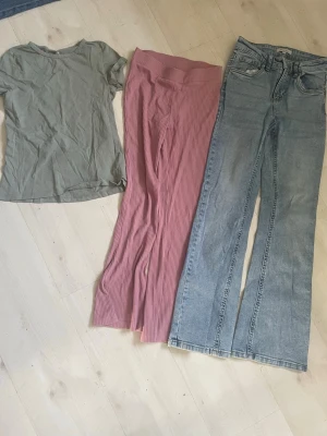 Rosa ribbade bootcut byxor+Jeans  - Säljer ett par rosa ribbade byxor med bootcut och hög midja. Byxorna har en mjuk och stretchig känsla, perfekta för en avslappnad men ändå trendig look. Passar dig som gillar färg och vill sticka ut lite extra.+Jesns + T-shirt 