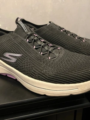 Skechers skor stl 40 - * SKÖNA FOTVÄNLIGA SKECHERS SKOR STL 40 INNERMÅTT 270 MM STORA SOM 42. GO WALK / ARCH FIT TEXTIL GRÅ/LILA HÖGER HÄL HAR EN BUCKLA , KÄNNS INTE NÄR SKON ÄR PÅ.  ANNARS MKT BRA SKICK