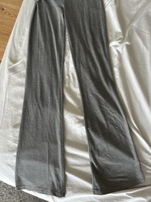 Grå utsvängda yogapants  - Snygga grå leggings med utsvängda ben och bred, vikbar midja. Mjukt och stretchigt material som sitter skönt på kroppen. Perfekta för en avslappnad och trendig look.