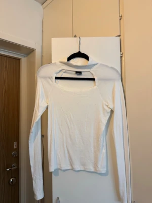 Gina tricot vit topp strl S - Vit långärmad topp med hög hals och en utskärning framtill. Toppen har en figurnära passform.