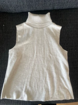 Beige ärmlös polotröja från Zara - Säljer en beige stickad ärmlös polotröja från Zara. 
