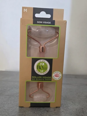 Ansiktsroller i rosenkvarts BO Paris - Snygg ansiktsroller från BO Paris i rosa rosenkvarts med metallhandtag i roséguld. Perfekt för ansiktsmassage och hudvård. Kommer i originalförpackning och har två rullhuvuden för olika områden i ansiktet. Som ny, den har bara stått i skåpet.