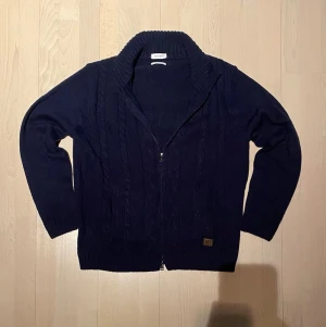Helzip-Pedro del Hierro - Säljer nu min helzip som har en komfort perfekt till sommaren, lätt att hänga över ryggen, ta av, och ta på. Kragen fungerar både som stående men går även att vikas ner. Tröjan är knappt använd och är i gott skick. 