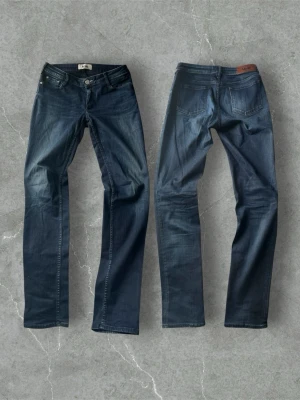 Vintage Acne Studios jeans - Snygga mörkblå jeans från A.P.C. med raka ben och klassisk femficksmodell. Jeansen har subtila slitningar framtill och kontrastsömmar. Tillverkade i kraftig denim med en tidlös look och läderpatch bak i midjan.