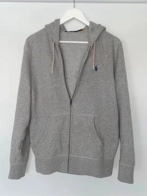 Ralph Lauren Hoodie - Säljer denna stilrena grå hoddie från Polo Ralph Lauren. I storlek S i mycket bra skick.