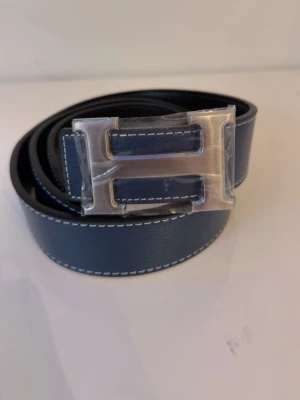 Blått skärp med H-spänne  - Dm vid intresse..
