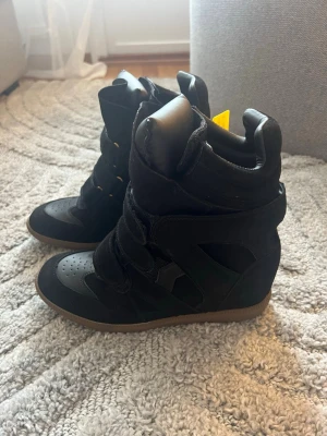 Svarta wedge sneakers - Säljer dessa snygga svarta isabel marant LIKNANFE sneakers med inbyggd kilklack eftersom de tyvärr är för små för mig🥰 Kommer inte med kartong men helt oanvänd