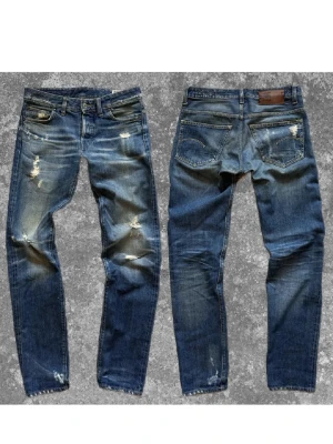Unika G-Star Raw Jeans - 👖 G-Star Raw Jeans (W29/L34) Blå denim med sick wash & slitningar  Ger en edgy men clean vibe   📏 Storlek/Mått: 29/34. A:40cm B:84cm C:23cm D:17cm E:17cm 👕 För: Man 🧵 Material: Bomull ⚡️ Skick: Mycket bra skick 💰 Pris: 479kr