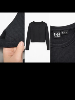 Svart ribbad croppad topp/träning NA - Svart croppad topp/träning från New Apparel med lång ärm och ribbad struktur. Toppen har en tight passform och är tillverkad i ett mjukt, stretchigt material som sitter snyggt på kroppen. 