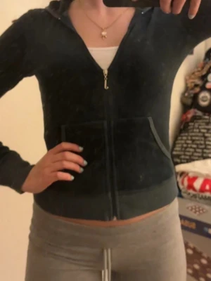 Juicy Couture velour zipup - Juicy Couture zip hoodie i velour med huva och fickor framtill. Klassisk modell med dragkedja och ribbade muddar. Perfekt för en chill och trendig look, ikonisk 00-talsvibe. Supermjuk och skön att ha på sig. Blågrön färg, lite svår att beskriva men jättefin!