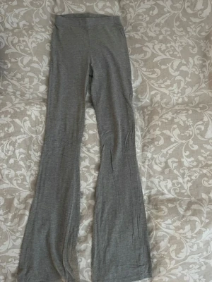 Grå utsvängda leggings - Snygga grå leggings med utsvängda ben och hög midja. Mjukt och stretchigt material som sitter skönt på kroppen. 