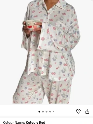 Vit pyjamas med röda bärmotiv, djerf avenue dupe - Supermysig vit pyjamas med röda och blå bärmotiv. Jag köpte tyvärr sättet lite för litet och ska bestella ett nytt i större storlek. Därav säljer jag detta☺️ Setet består av en långärmad skjorta med krage och knappar samt matchande byxor med lös passform. Perfekt för chilliga hemmakvällar och sömn. Materialet ser ut att vara mjukt och luftigt, perfekt för att slappa. 