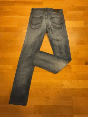 Blå raka jeans från Jack & Jones - Säljer ett par ljusblåa jeans från Jack and Jones. Säljer pga att dom e lite för små på mig. Bra skick. Str 28/30. Pris kan diskuteras!!