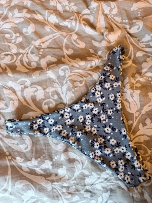 Bikiniunderdel +överdel  - Blommig bikiniöverdel samt en svart överdel som har en diskret detalj i mitten !