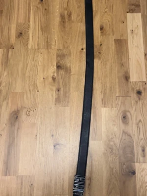 Svart skärp Amiri - Snyggt svart bälte från Amiri i äkta skinn med en stor, silverfärgad logotyp-spänne. Perfekt accessoar för att lyfta din outfit med en exklusiv touch. Klassisk design som passar till det mesta.