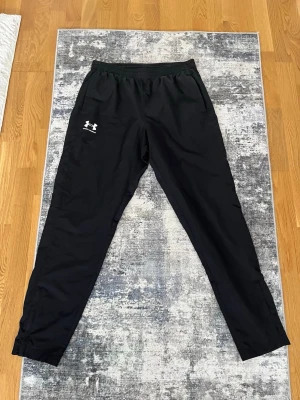 Under Armour Windbreaker - Säljer dessa Under Armour windbreaker/vind byxor som är i väldigt nytt skick och väldigt snygga, Perfekta till våran och sommaren och vattentäta. Priset kan diskuteras 
