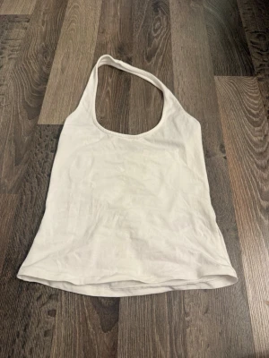 Vit ärmlös linnetopp från Nelly  - Säljer en enkel och stilren vit linnetopp från Nelly. 
