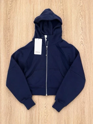 lululemon Zip Hoodie - • Brand: lululemon • Model: Zip Hoodie • Size: 4 (XS/S) • Color: Dark Navy • Condition: brand new Classic lululemon zip hoodie in dark navy. Soft, stretchy fabric with a flattering fit. Perfect for the gym, yoga or everyday wear. 