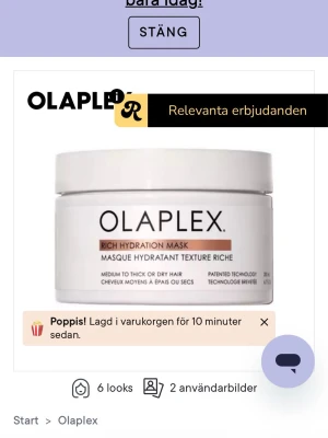 Olaplex Rich Hydration Mask - En vit burk med Olaplex Rich Hydration Mask, en återfuktande hårmask för medeltjockt till tjockt eller torrt hår. Masken ger intensiv fukt och vård till håret och kommer i en stilren, rund förpackning med svart text.