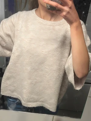 Lager 157 - Mysig beige stickad tröja från lager 157 med fluffig yta och rund halsringning. Tröjan har en avslappnad passform och långa ärmar, perfekt för att hålla sig varm under kyliga dagar. Passar till jeans eller leggings för en chill look.
